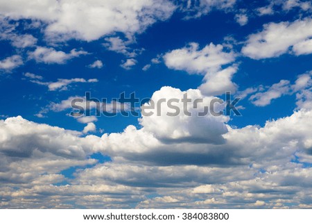 white clouds against blue sky illuminated by the sun
