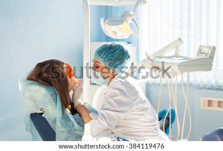 woman dentist at work with patient Royalty-Free Stock Photo #384119476