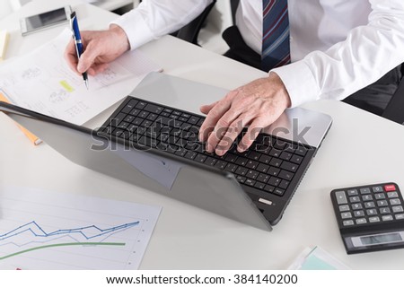 Businessman working with documents and laptop