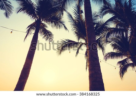 Silhouette palm tree on the beach and sea around beautiful luxury swimming pool in sunset - Vintage Filter and Boost up color Processing