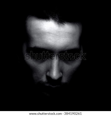 Portrait of man in shadow. Black and white silhouette.
