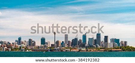 Panoramic view at Sydney city urban skyline from Western Plains with blue sky and clouds on a bright day