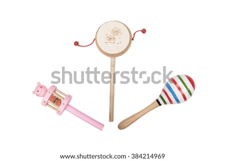 Wooden rattles and drum on white background