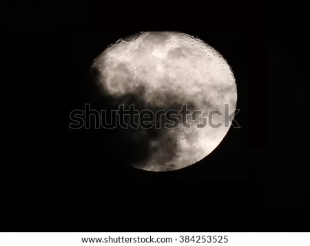 Three nights after full moon behind cloud on 25 february 2016.