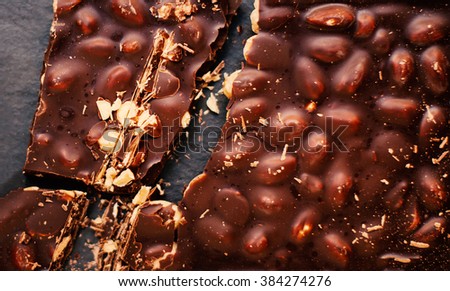 Chopped chocolate bar background. Chocolate background/ nut chocolate. Chocolate 