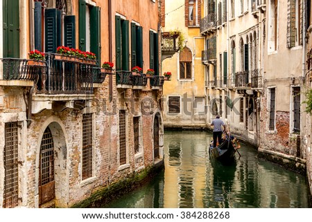 Gondola in picturesque Venice Canal - Venice, Italy Royalty-Free Stock Photo #384288268