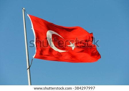 Turkish flag against a blue sky.