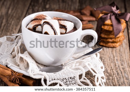 Mug with hot chocolate, marshmallows and homemade oat cookies.