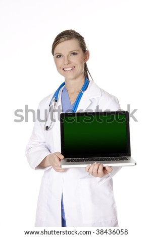 Beautiful Caucasian woman doctor or nurse holding a laptop computer with a clipping path around screen. Isolated on a white background