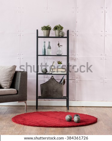modern living room bookshelf behind stone soft wall with red carpet 