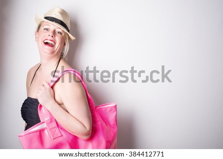 Young beautiful female model in bathing suit laughing and enjoying herself - Swimwear and vacation concept - Close up 