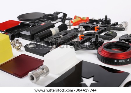 Workplace of the photographer. Photoaccessories set - lens cap, filters, frames, adapters, remote shutter control, lens pen, flash diffuser, brush, tripod, background clamps, macro tube.