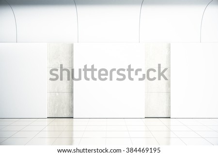 Blank square posters on concrete wall in empty hall, mock up, 