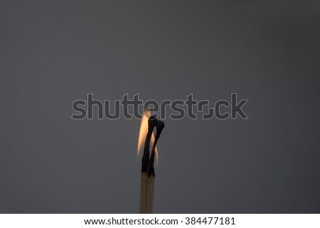 Two burning match humans on a dark background. Idea of couple in love.