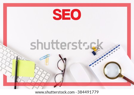 High Angle View of Various Office Supplies on Desk with a word SEO
