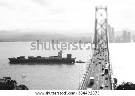 Freight Ship Passing under Bay Bridge, San Francisco Bay. Black & White. Tilt-shift photography. Miniature effect.