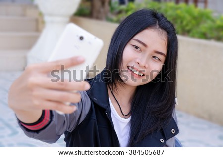 beautiful women student with her cellphone and iced coffee,close up