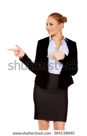 Businesswoman with finger pointing for copyspace or something