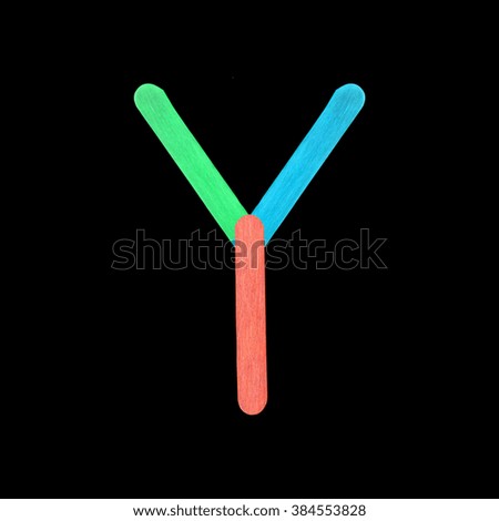 English alphabet from colorful ice cream wooden on black background