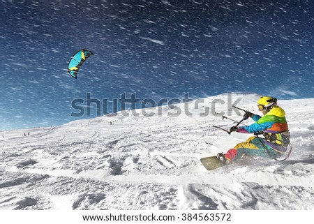 Snowboarder with kite on free ride. Sheregesh resort, Siberia, Russia Royalty-Free Stock Photo #384563572