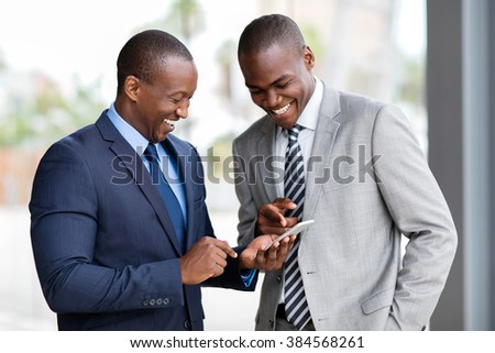 happy african businessmen using smart phone Royalty-Free Stock Photo #384568261
