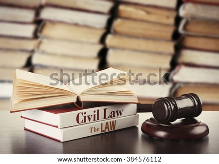 Wooden judges gavel and law books on table in library