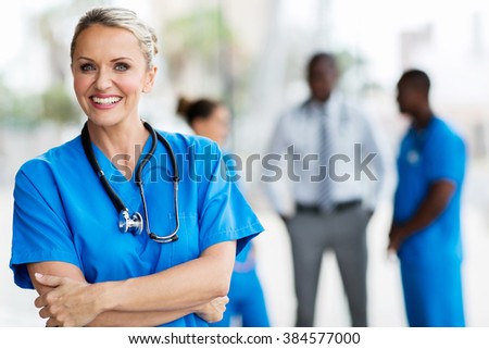 confident mid age medical doctor in hospital