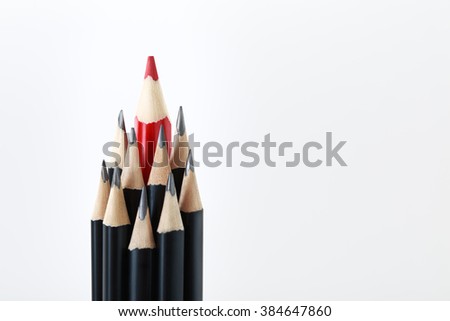 Black pencils with a red one in the middle