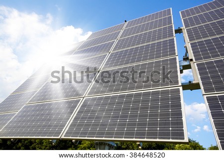 Low angle view of solar photovoltaic cell panels in bright sunlight. 