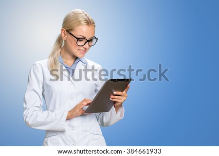 Beautiful smiling doctor woman in medical gown