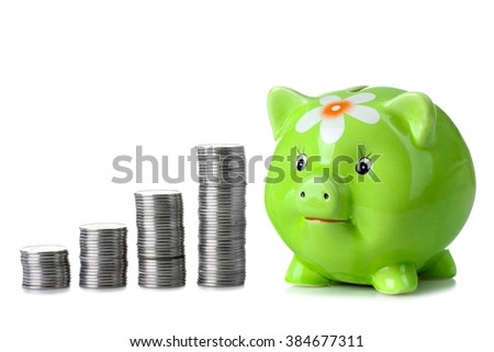 cute green piggy Bank with flower is painted with silver coins stacked in columns on a white isolated background