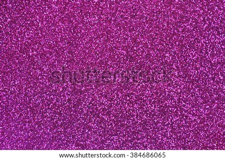 Closeup abstract background glittery texture photo of glitter in magenta shade
