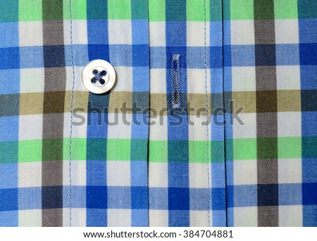 Green blue brown white plaid shirt macro shot
