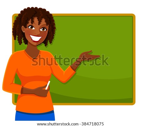 happy teacher of African ethnicity standing next to a blackboard