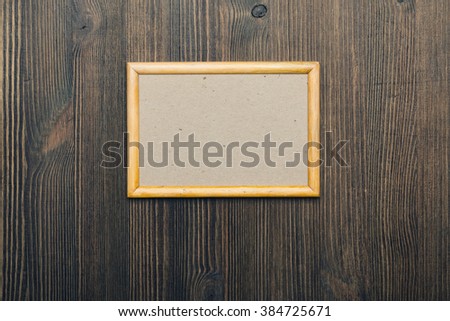 wooden photo frame on old wooden wall