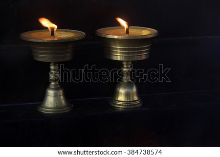 butter lamp in black background, closeup of photo 
