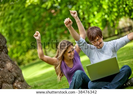 Happy people with laptop computer outdoors
