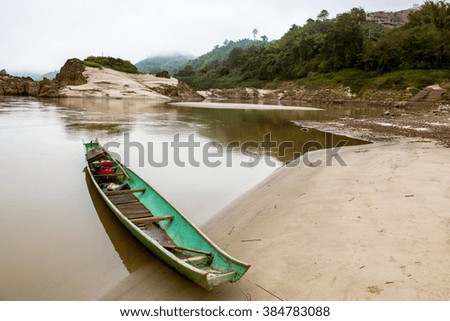 A traditional fishing boat from Laos on the banks of Mekong