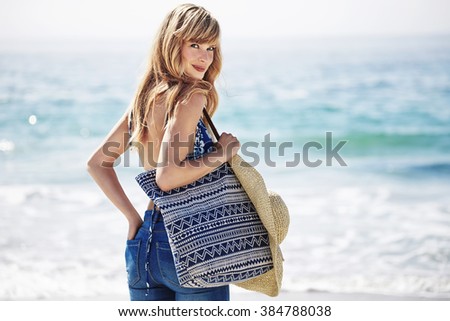 Beautiful beach babe with bag, portrait