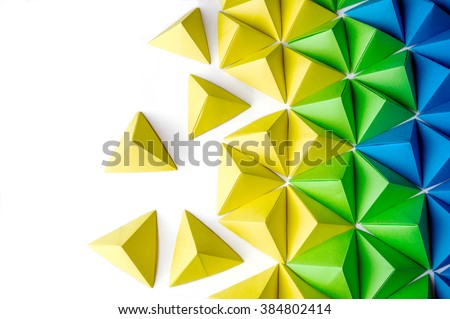 Origami tetrahedrons background. Futuristic polygonal composition with copy space on the left side.