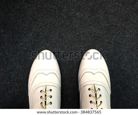 Classic male white leather shoes on carpet background