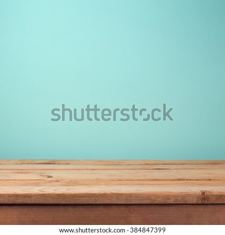 Empty wooden deck table over mint wallpaper background