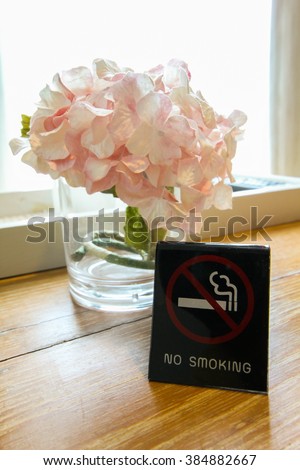 No smoking sign on a table in hotel room.