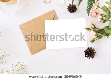 Stylish branding mockup with flowers to display your artworks. Cute vintage mock up on wooden background.