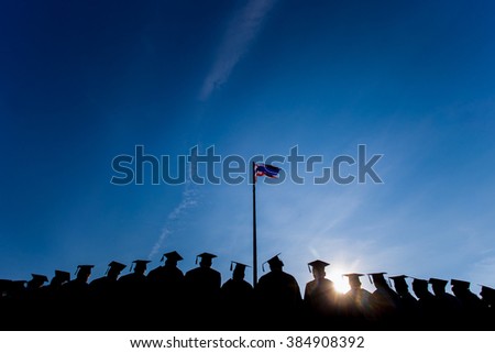 Education Graduation with flag and blue sky background Royalty-Free Stock Photo #384908392