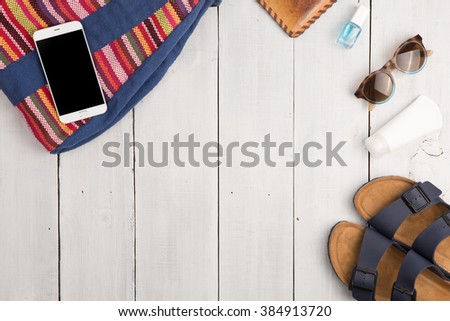 Travel concept - summer women's fashion with bag, phone, sunglasses and sandals Royalty-Free Stock Photo #384913720
