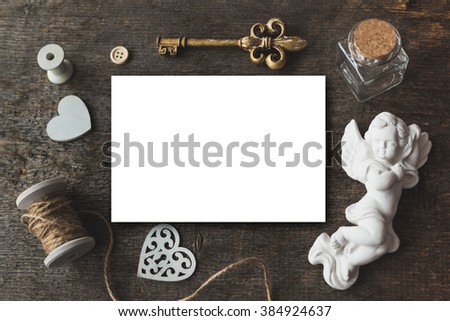Stylish brending mockup with flowers to display your artworks. Cute vintage mock up on wooden background. Flat lay top view.