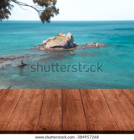 Beautiful view of the Mediterranean Sea over old dark wooden table or board. Collage. Selective Focus. Toned.