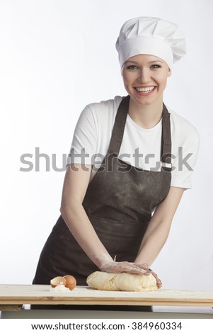 Woman knead the dough on a white background