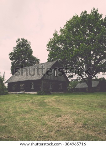 country house with oak trees in green summertime - vintage effect
